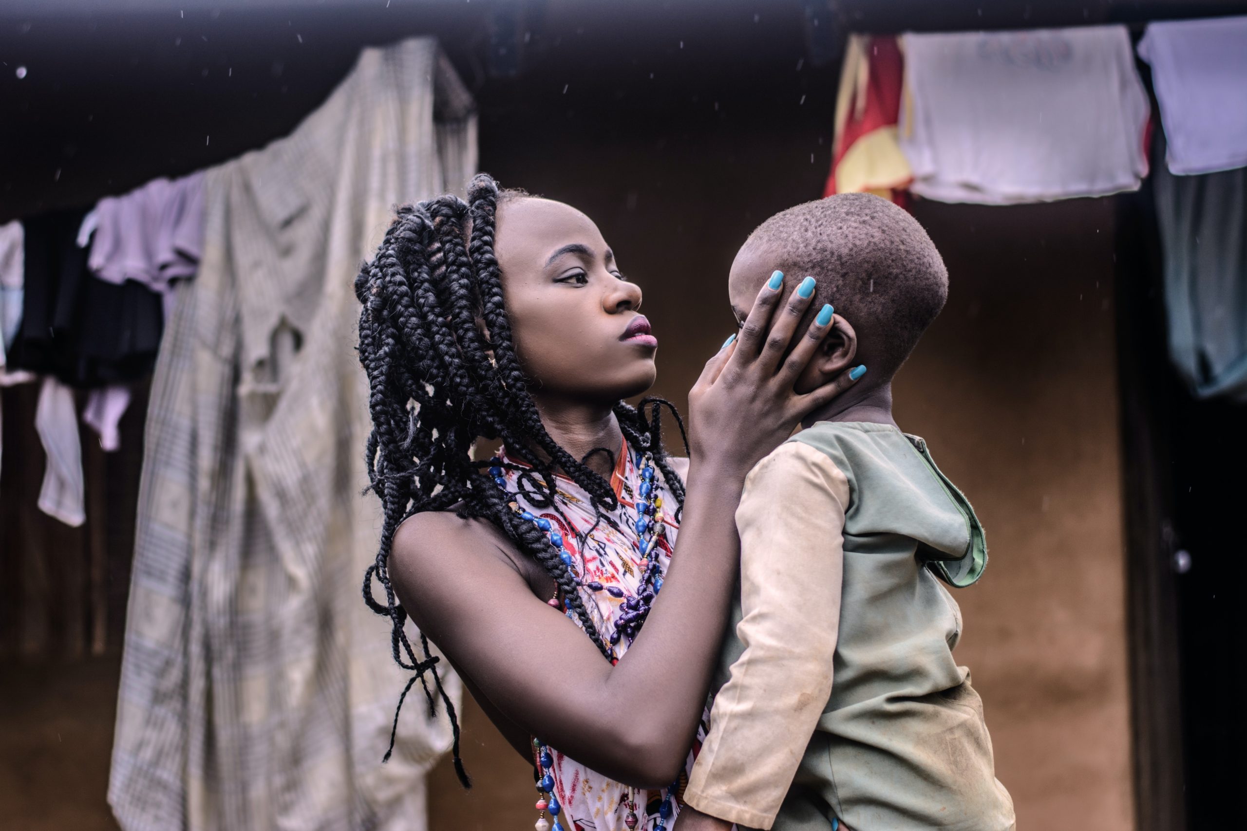 girl-with-braided-hair-standing-while-carrying-boy-wearing-1046601