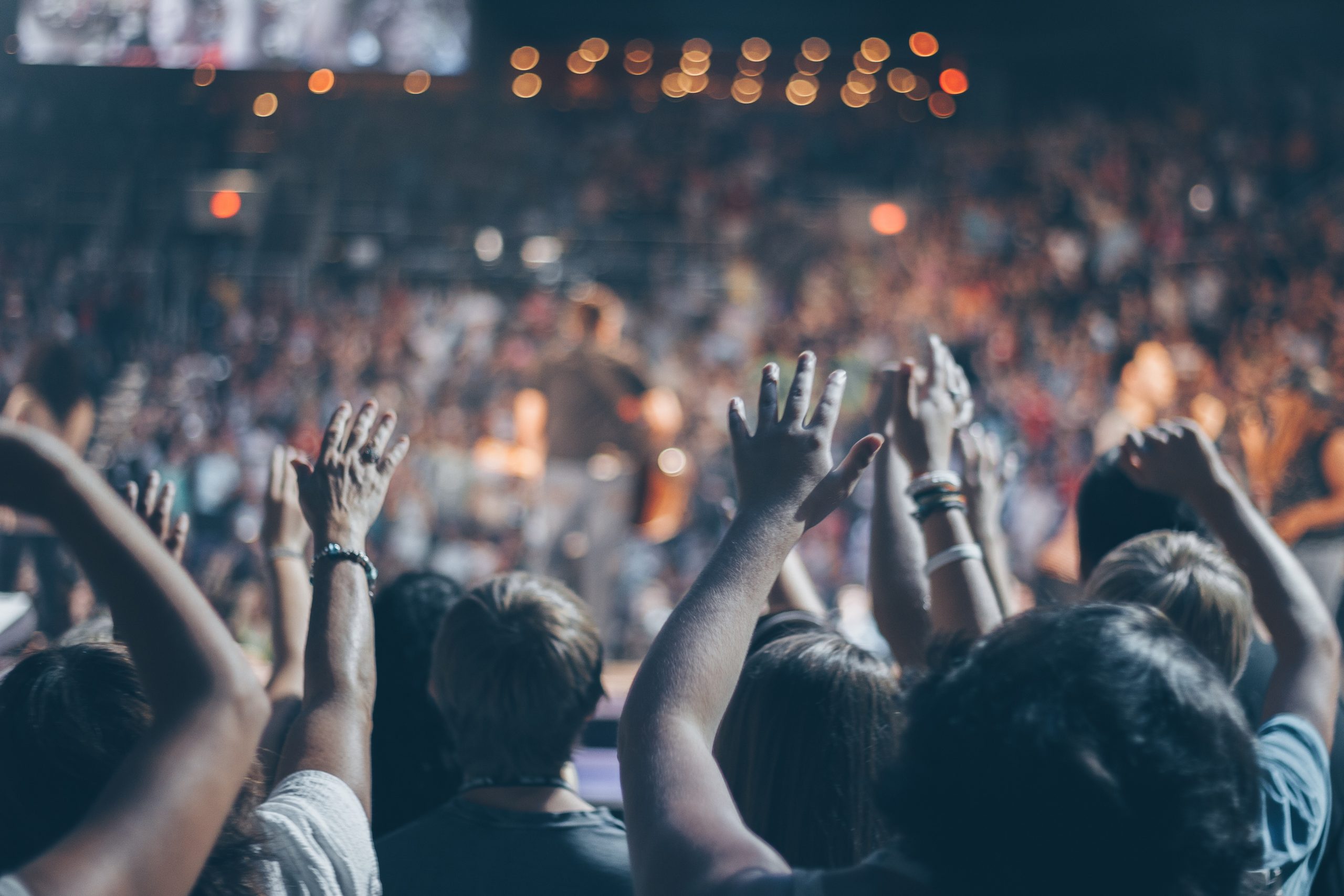 group-of-people-raise-their-hands-on-stadium-976866